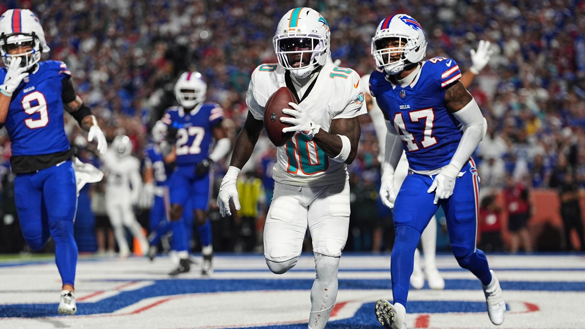 Miami Dolphins quarterback Tyreek Hill scores a touchdown
